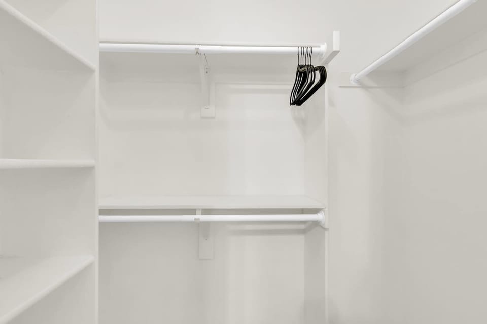 Large walk-in closet in the primary suite, designed for convenience with plenty of hanging and storage space.