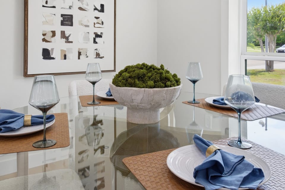 Dining Table with seating for group meals and easy access to the open kitchen. Pour a glass of wine, gather everyone, and enjoy long dinners in Frisco.