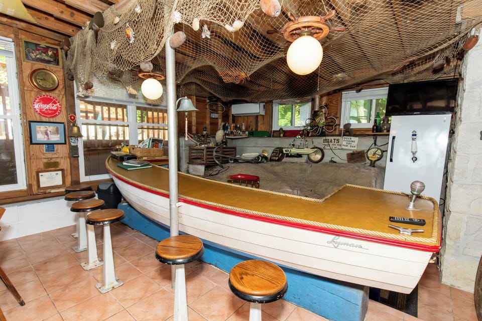 Gather around this one-of-a-kind boat bar where nautical nostalgia meets island charm—complete with fishing nets overhead, vintage décor, and plenty of room for your group to share stories over drinks.