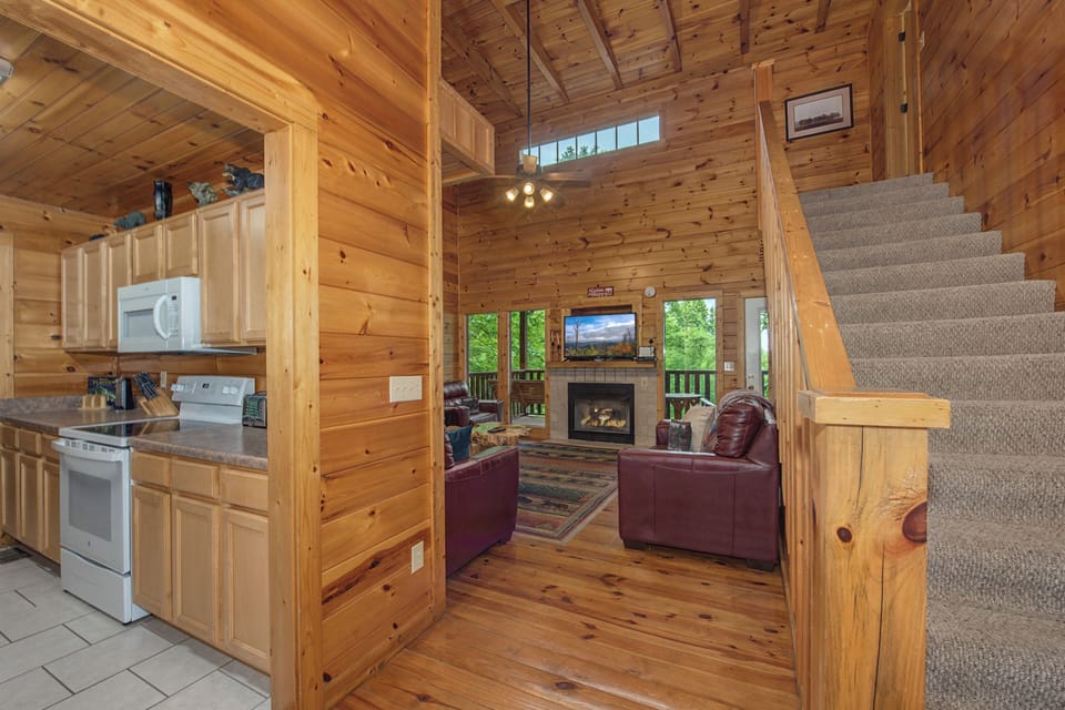 Step inside your cozy mountain retreat, where warm wood surrounds you at every turn. Relax on plush leather sofas by the fireplace, cook in the well-equipped kitchen, and feel the cabin charm wrap around you.