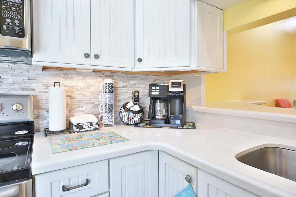 Your bright, fully equipped kitchen makes meal prep a breeze with modern appliances, ample counter space, and a charming tile backsplash that adds character.