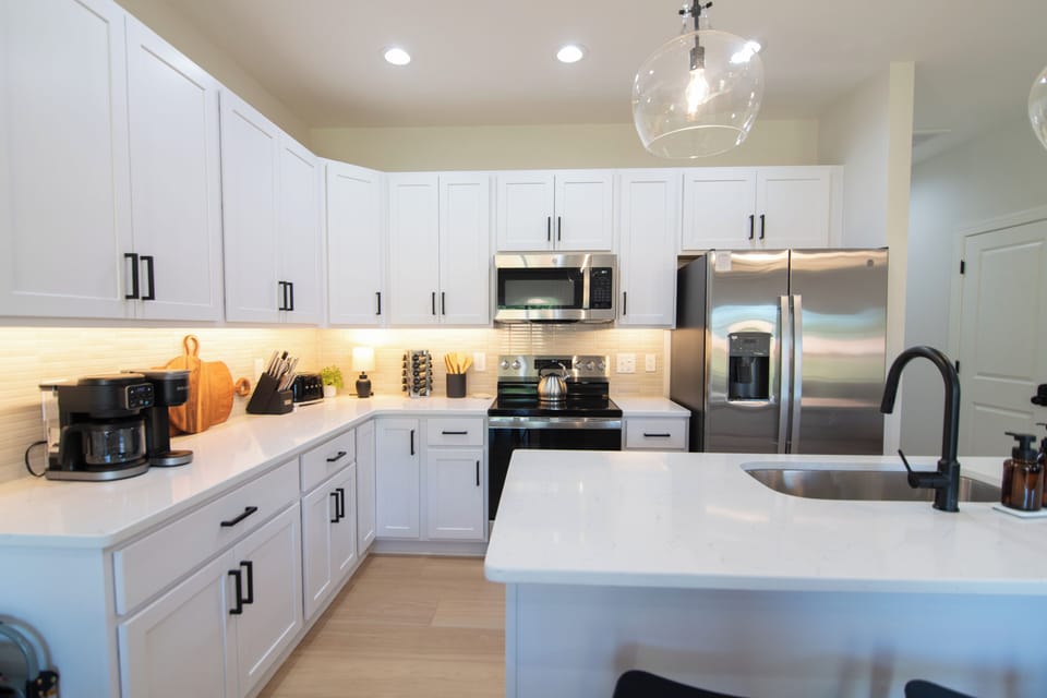 Bright, open kitchen featuring stainless steel appliances and a clean, functional layout with plenty of space to cook and gather.