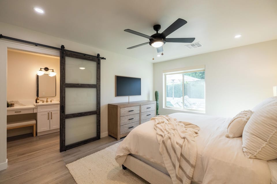 King suite with barn door, pool views & wall-mounted TV