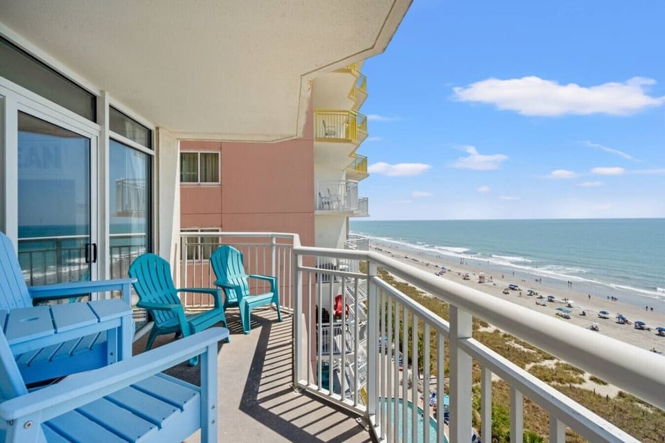Teal Adirondack chairs invite you to relax on this private oceanfront balcony, seating for 4 and breathtaking Atlantic views.