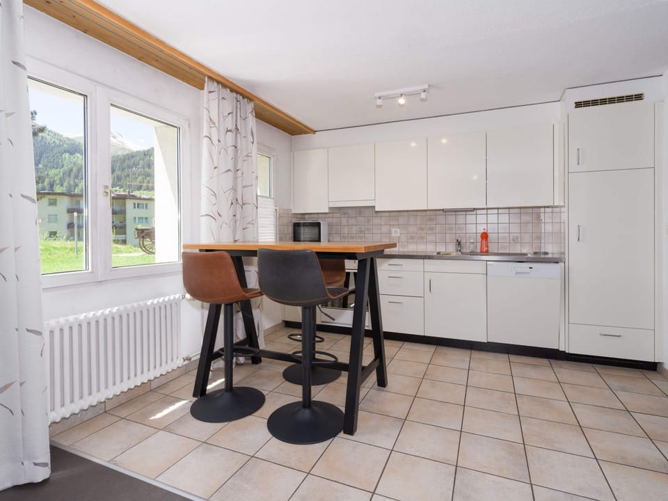 Fully equipped kitchen with breakfast bar and dining space
