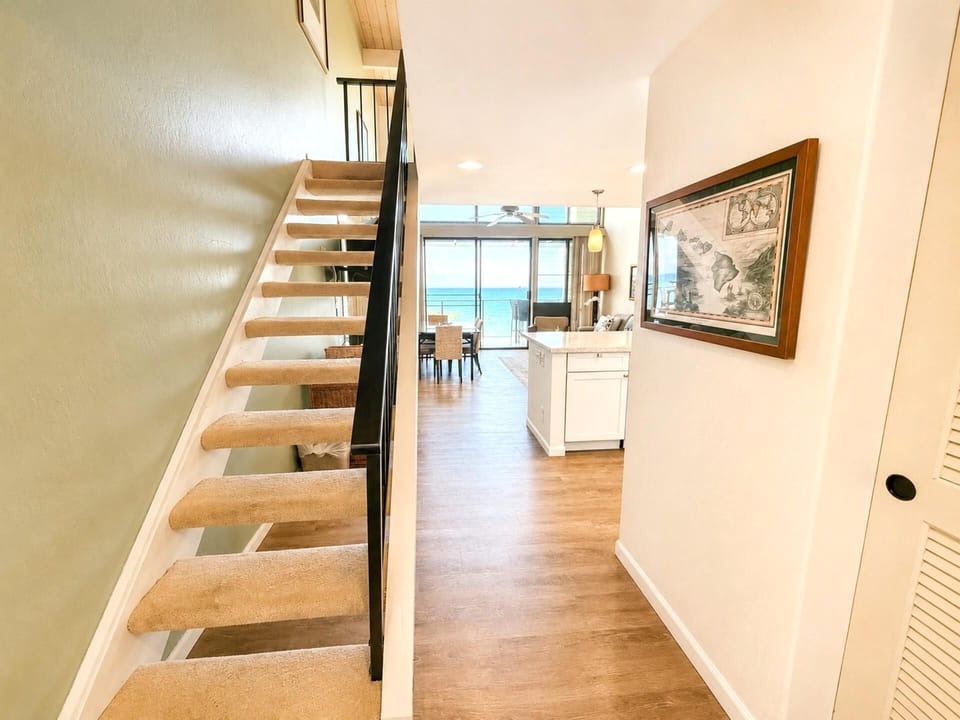 A light-filled interior space with a charming staircase and warm wood tones