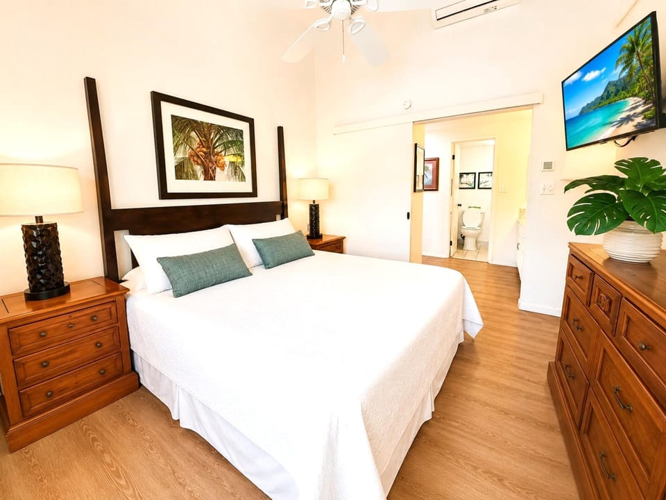 A second angle of the primary bedroom shows the room's generous proportions and calm palette