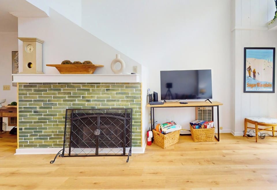 Picture yourself unwinding here—bright, natural light fills your living space, where a cozy fireplace sets the mood. Kick back with a good show on the flat-screen or enjoy mountain views through the window.