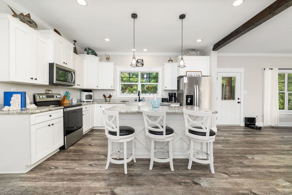Fully equipped kitchen with modern appliances and open layout.