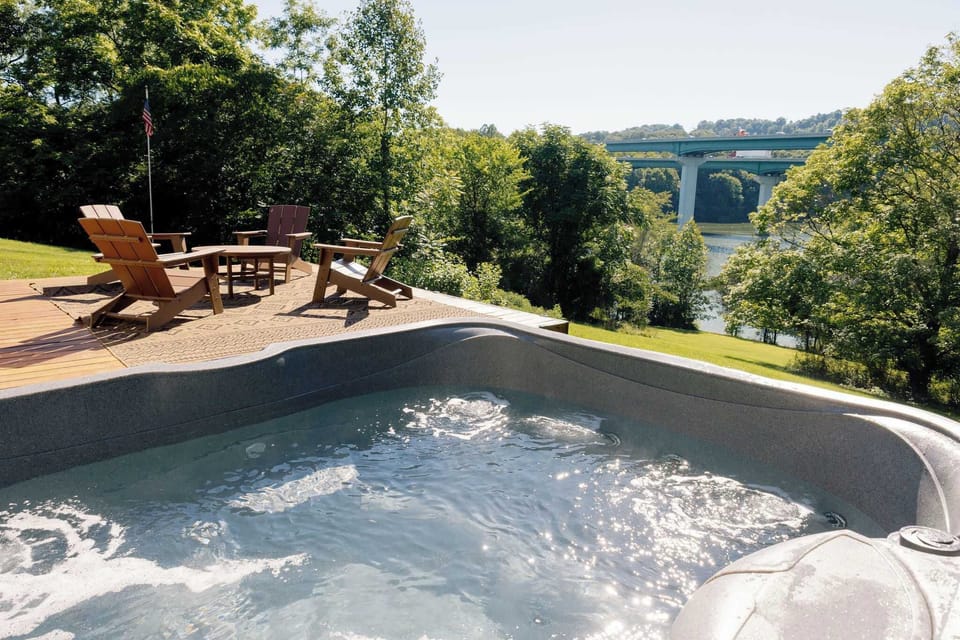 Relax in the hot tub while taking in peaceful water views, surrounded by nature and a spacious deck perfect for morning coffee or evening sunsets.