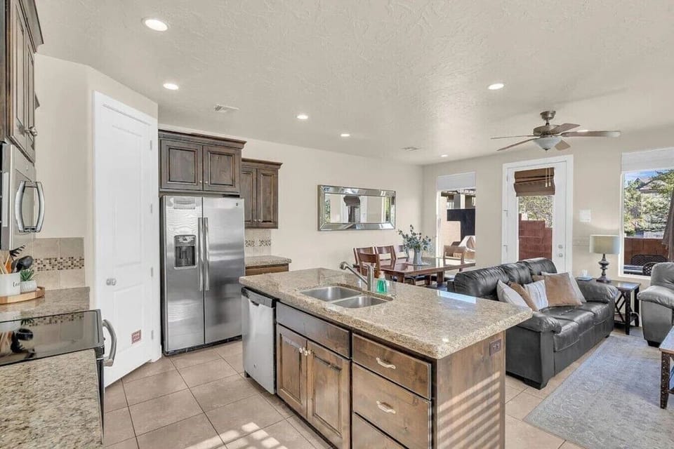 Spacious kitchen with island, stainless steel appliances, and open layout