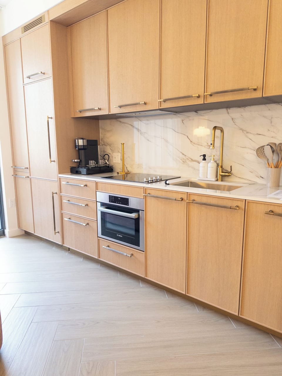 Fully equipped kitchenette — marble backsplash, cooktop and convection oven