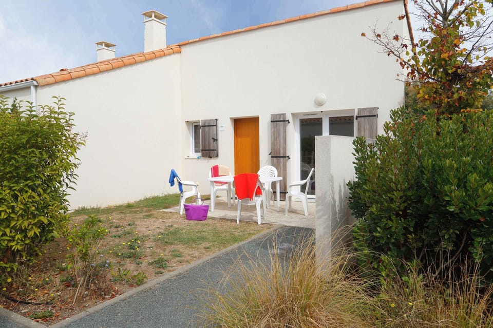The exterior of the apartment, set among the natural dune vegetation of the Vendée coast.