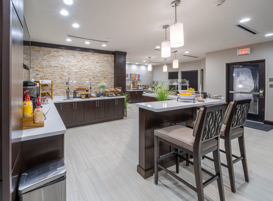Gather around the breakfast bar, where fresh pastries and tasty treats await in a chic environment.