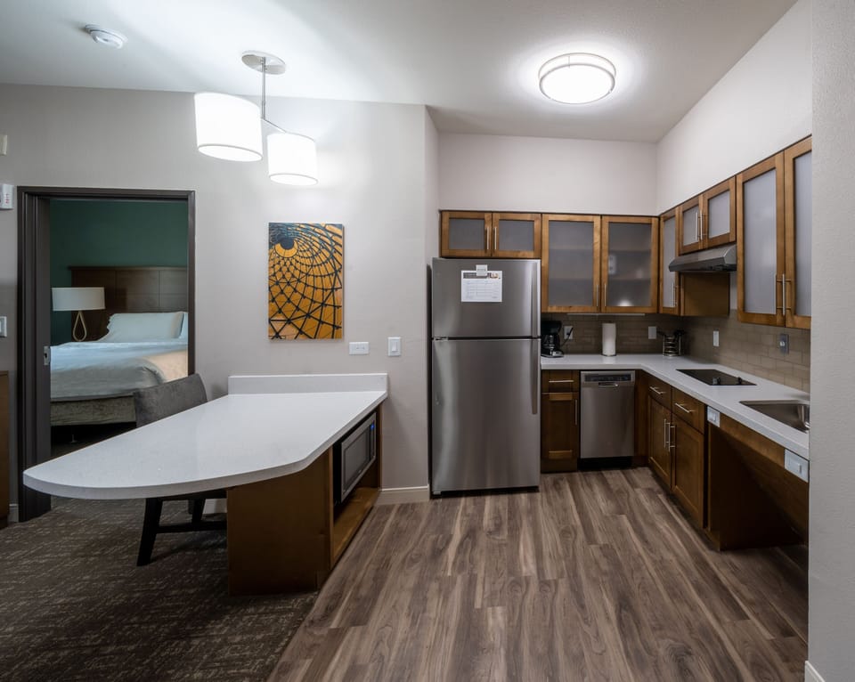 Cook and gather in a fully equipped kitchen featuring modern appliances and a spacious layout for easy dining.