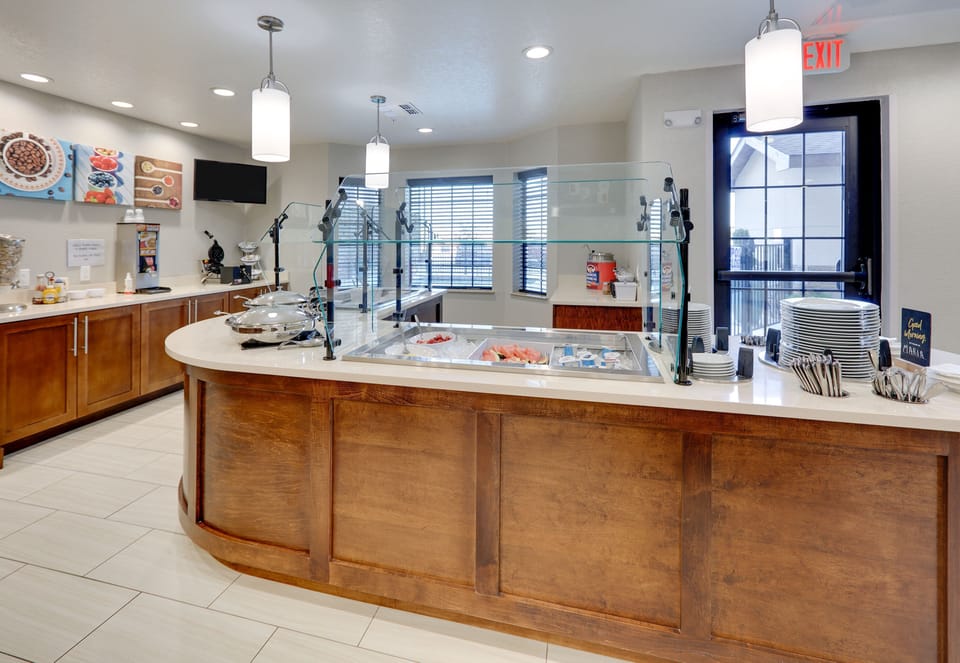 A breakfast area featuring various hot and cold food options.