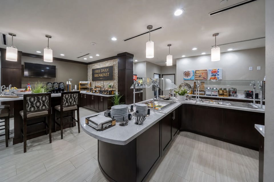 Savor a delicious free breakfast in a stylish dining area, complete with modern seating and fresh decor.