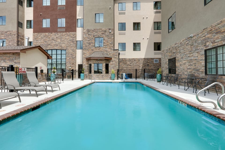 A shimmering pool bordered by lounge chairs invites relaxation and fun.