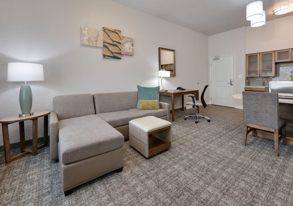 Inviting open-layout suite with stylish décor and sofa seating.
