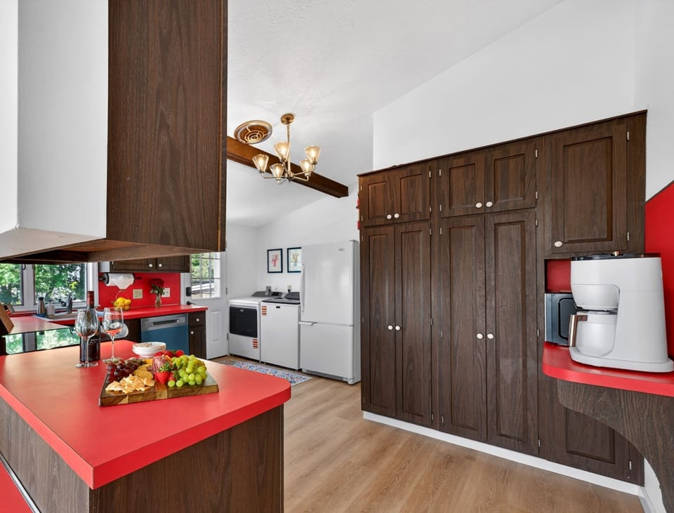 Beautifully designed kitchen with warm wood accents and modern appliances, perfect for everything from quick breakfasts to cozy dinners and late-night conversations.