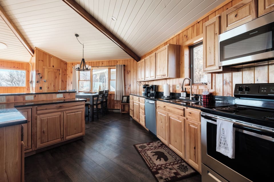 Wide kitchen view with plenty of workspace and an easy path to dining and living areas. Enjoy meals together, then relax by the fireplace or head out to the deck.