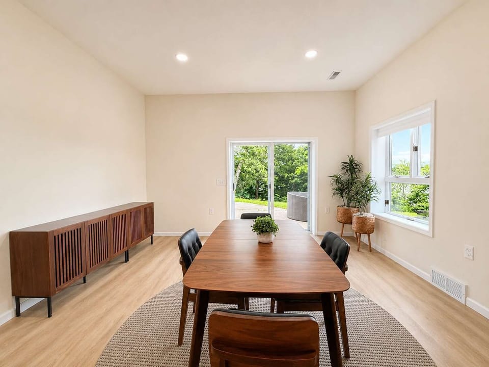The lower level boasts an additional kitchen, dining area, & den​
