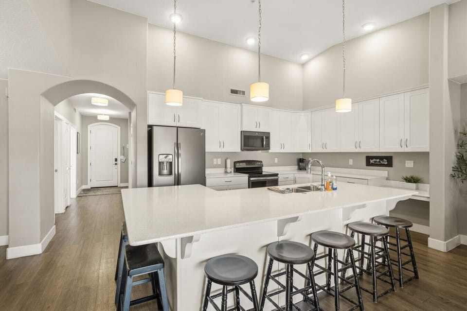Fully equipped kitchen with island, breakfast bar, and modern appliances.
