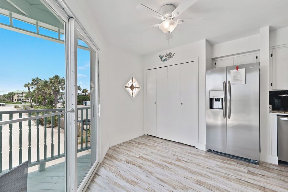 Bright coastal space with balcony access, palm views, and airy natural light