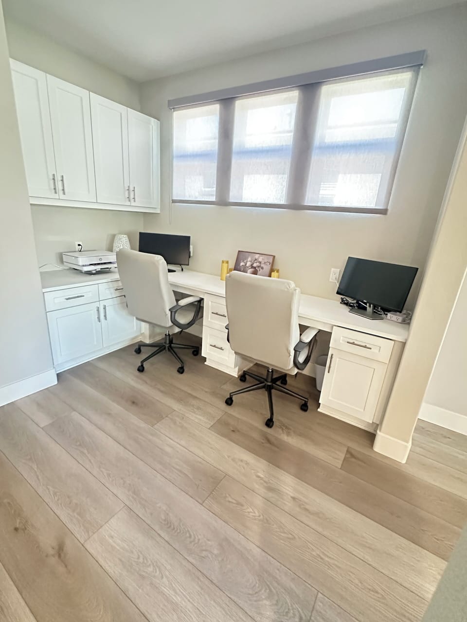 Office with double desks, monitors and printer