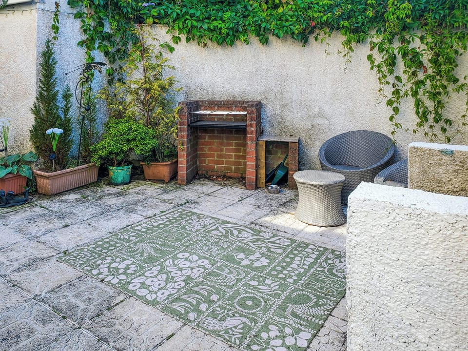 Barbecue and enclosed seating area | Wren Cottage Apartment, Fishguard
