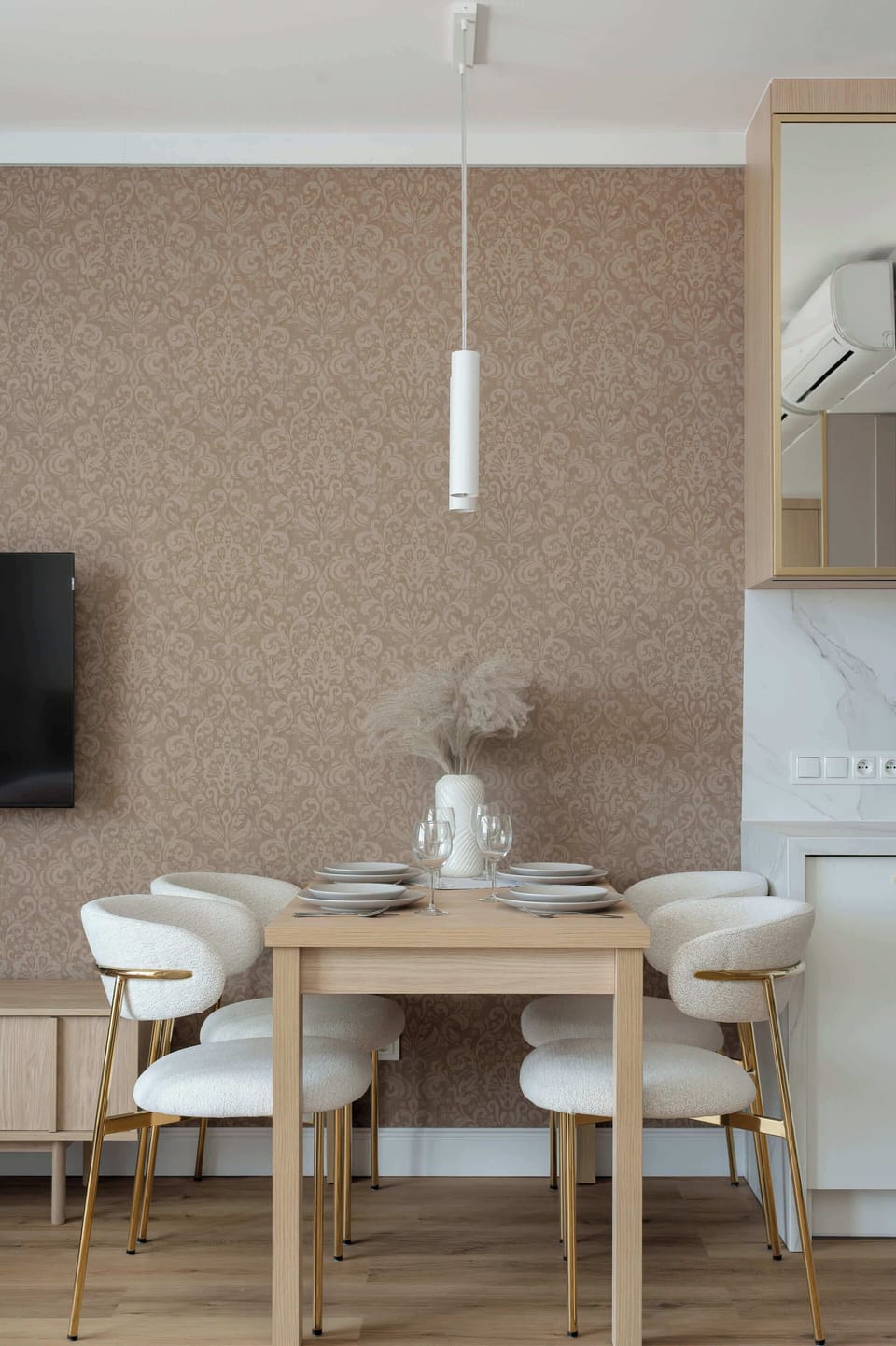 Alternative view of the living space with dining table and kitchen.