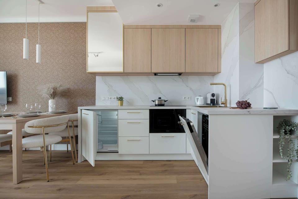 Bright kitchenette equipped with modern appliances, ample storage, and generous countertop space.