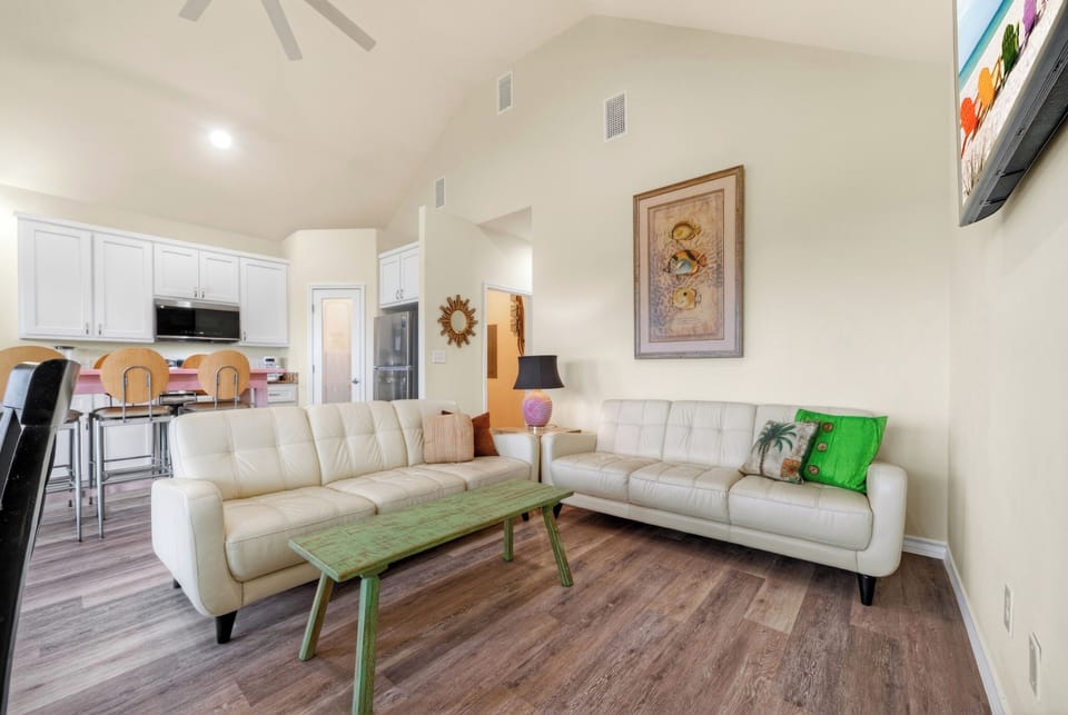 Bright and airy living room boasting soaring vaulted ceilings and ample space for relaxation or entertaining.