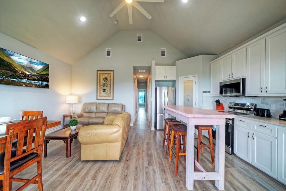 Spacious open-concept living room with vaulted ceilings.