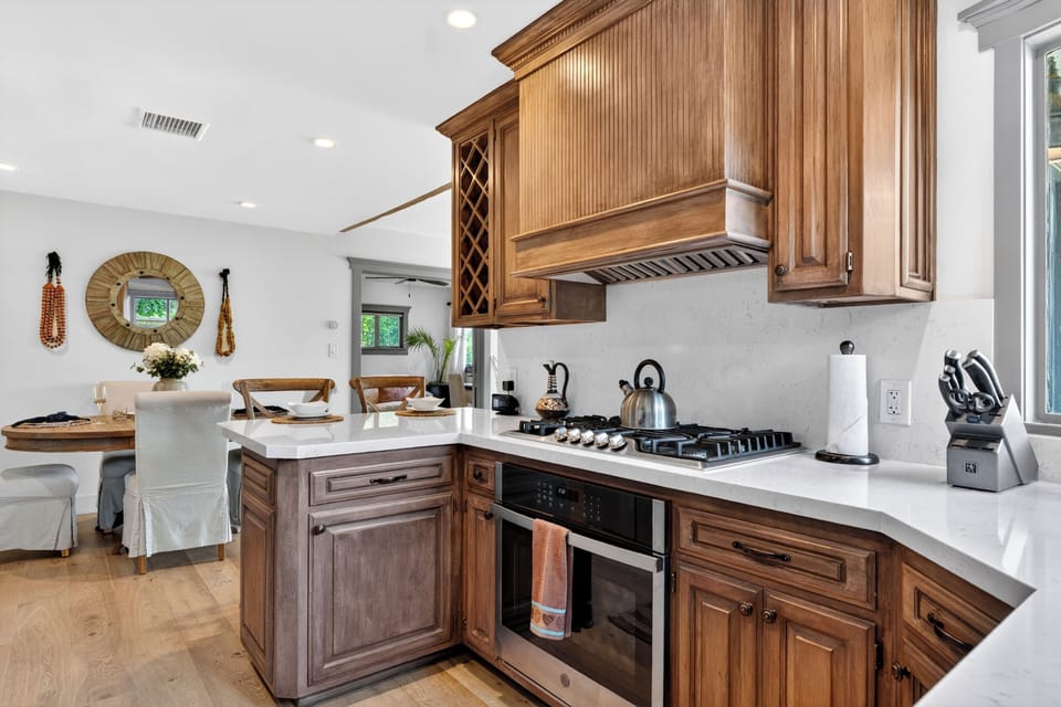 A chef’s delight. The kitchen offers high-end stainless steel appliances, a convenient breakfast bar island, and a built-in wine rack.