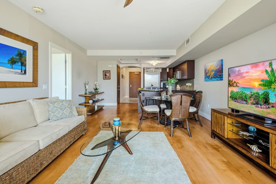 Expansive view of the main living room showcasing the seamless layout and modern glass coffee table.