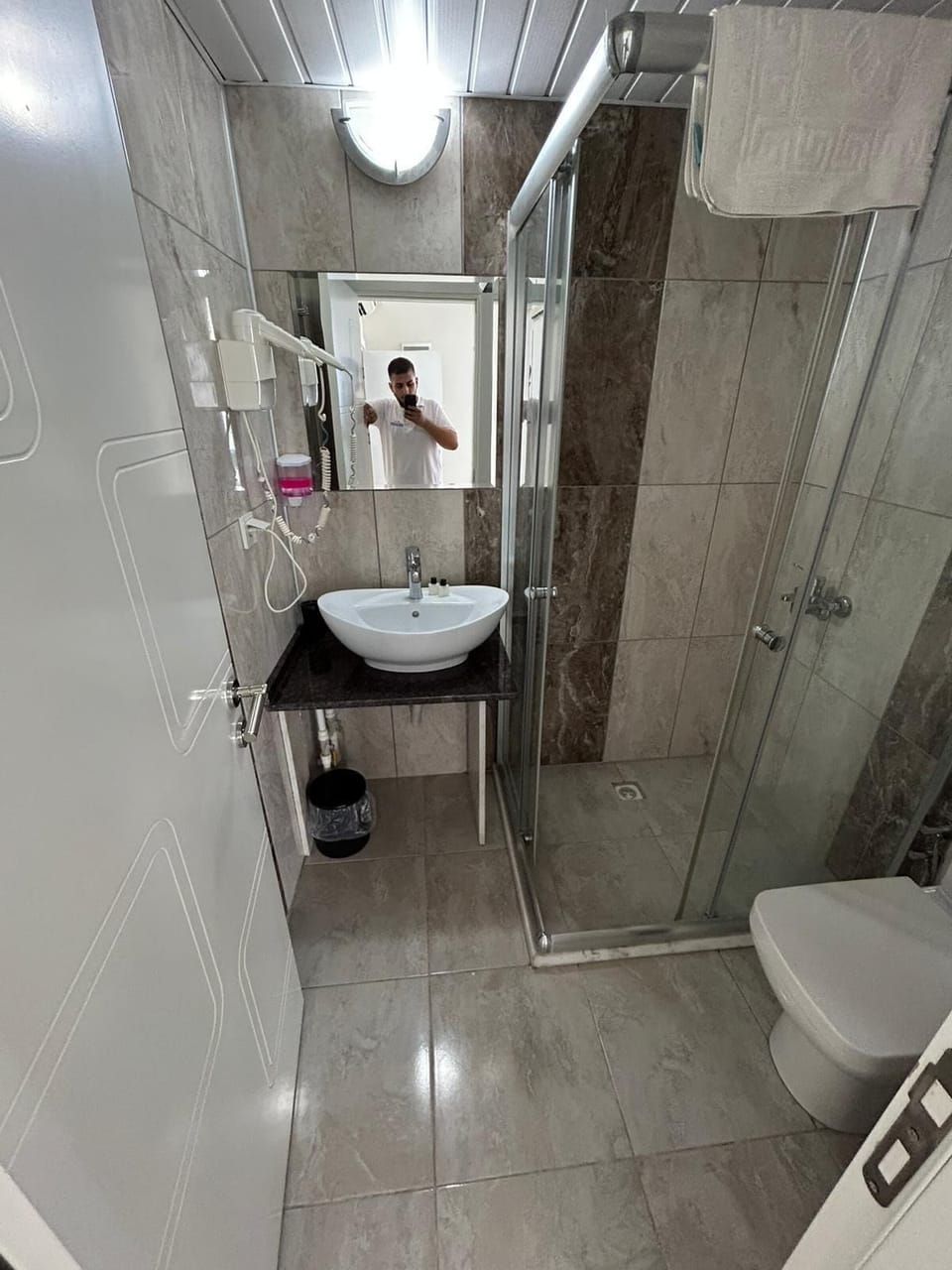 Shower, hair dryer, slippers, towels