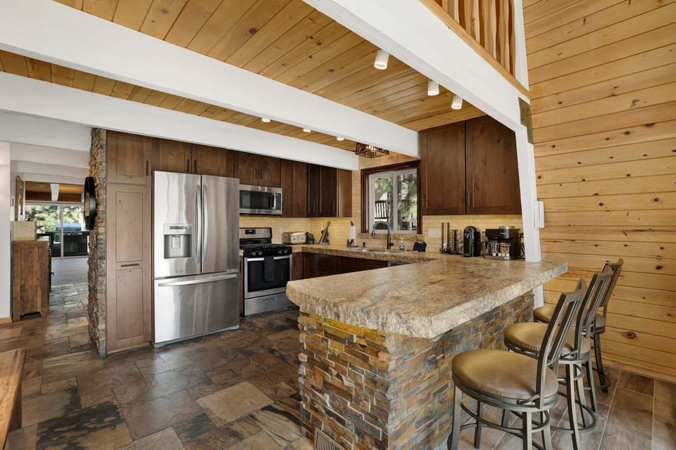 Fully equipped cabin kitchen with ample cabinetry, microwave, stove, fridge, and coffee maker, perfect for cooking meals, morning coffee, and feeling right at home during your stay.