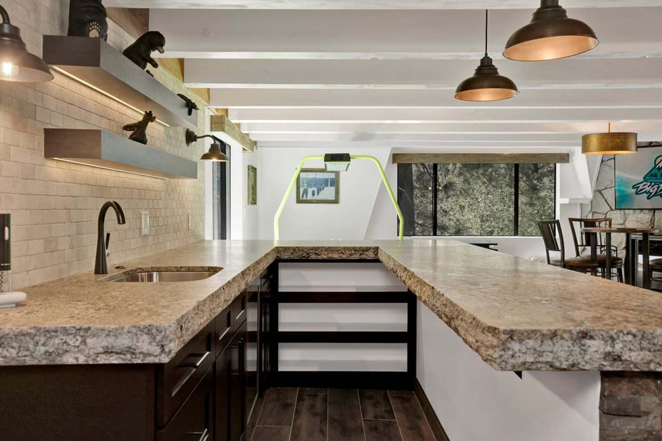 Modern indoor bar and game area with stylish seating, warm lighting, and a fun atmosphere perfect for relaxing and entertaining.