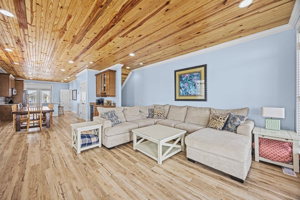 Sink into plush comfort on this spacious sectional while admiring the stunning natural wood ceiling above. Open, inviting, and bathed in warmth—your perfect home away from home.