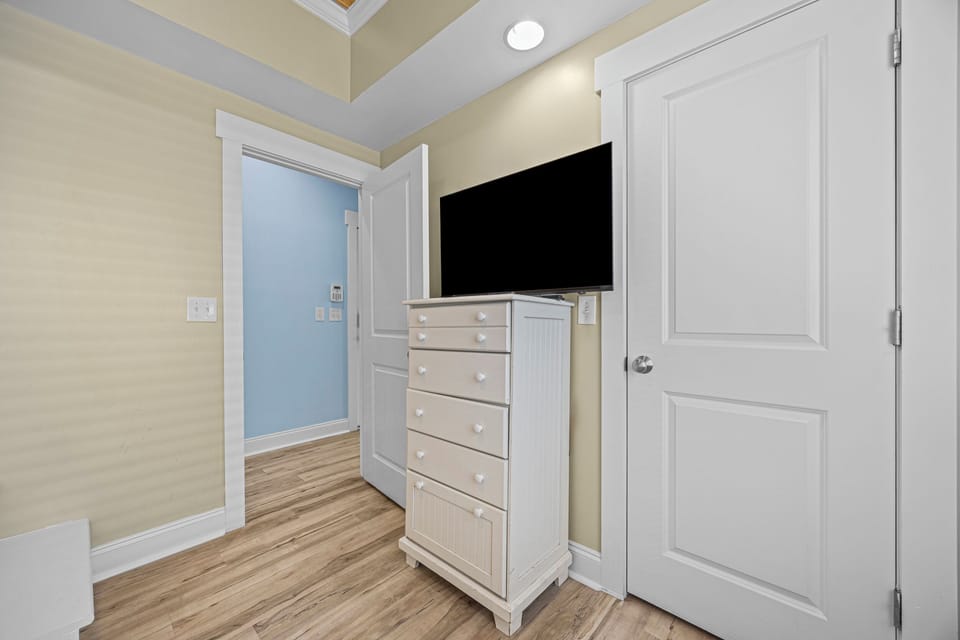 Your cozy bedroom features a fresh coastal palette, a flat-screen TV for movie nights, and plenty of dresser space to unpack and settle in.