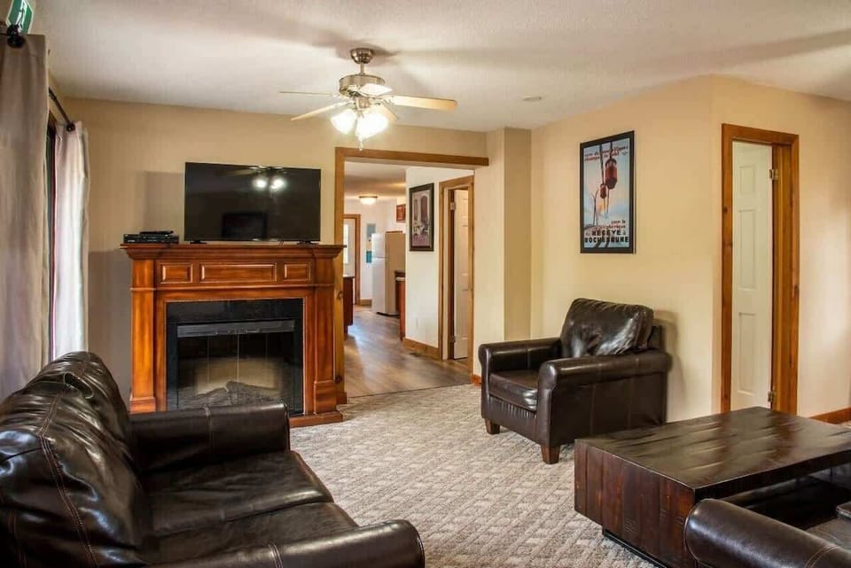 living room features 2 sofas, 2 arm chairs, an electric fireplace, smart TV