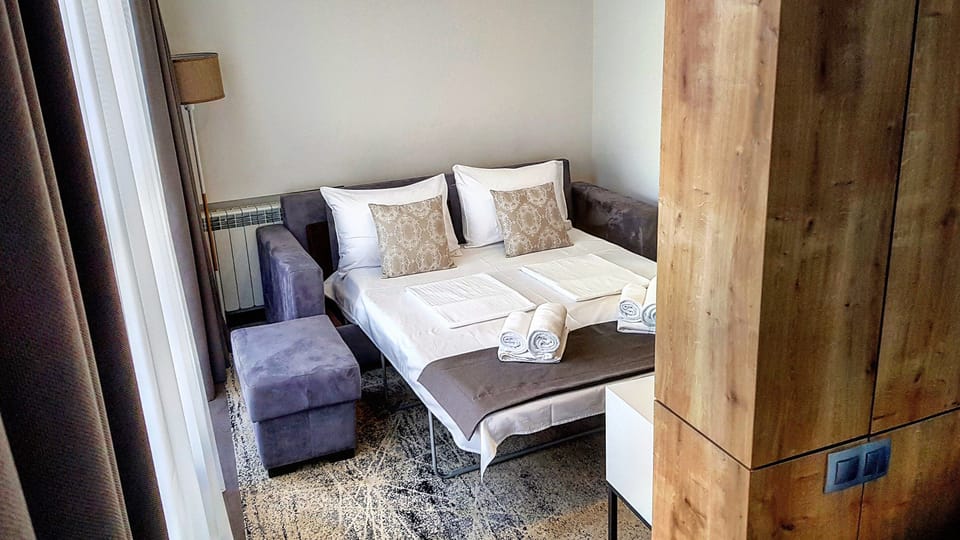 Junior Suite | Living area | 50-inch flat-screen TV with digital channels