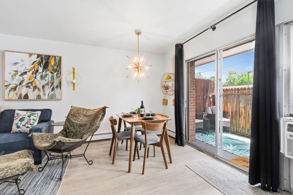 Inviting dining area bathed in natural light. Your private patio awaits just beyond the glass doors!