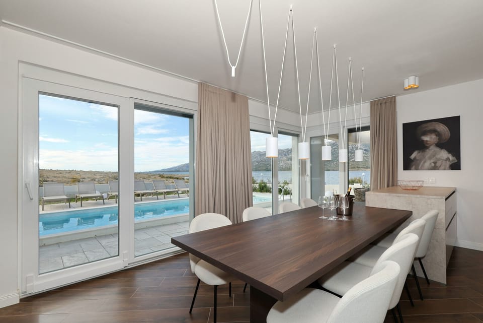 Elegant dining area at Villa Wave of Love with direct views of the pool, terrace and sea.