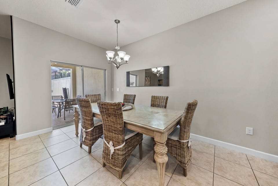 Step outside to your private oasis with a sparkling pool in a sleek screened enclosure for added privacy and comfort. The inviting patio is ideal for lounging in the sun while enjoying the peaceful atmosphere.