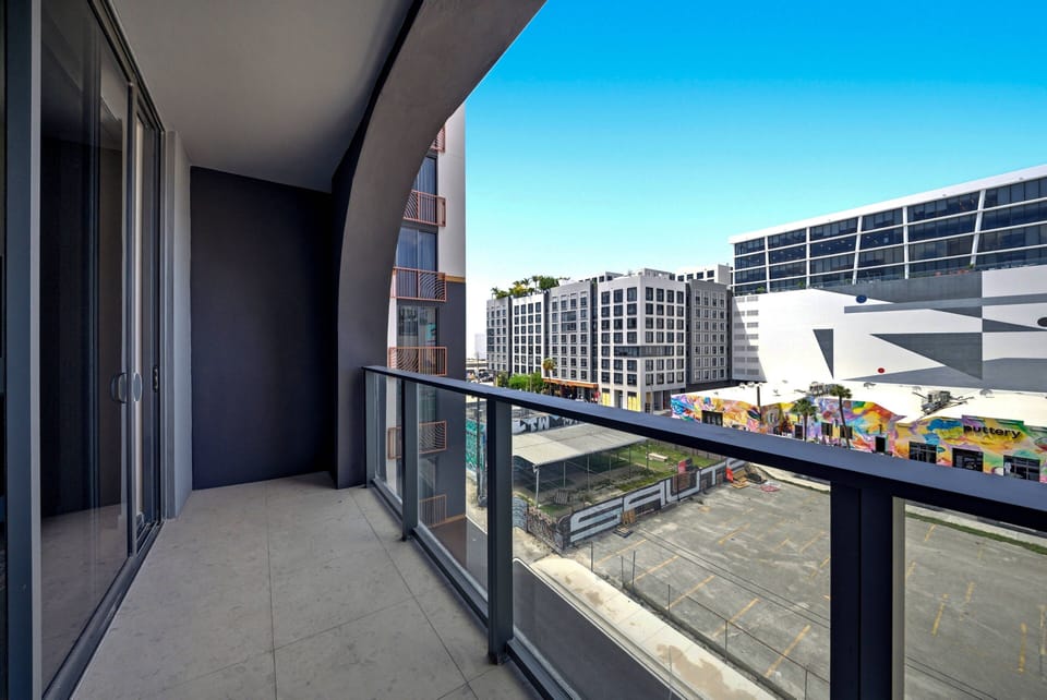Step outside to your spacious balcony, where sleek glass railings frame vibrant city views. Enjoy the fresh air and natural light pouring in, creating a perfect spot for morning coffee or evening relaxation amidst urban energy.