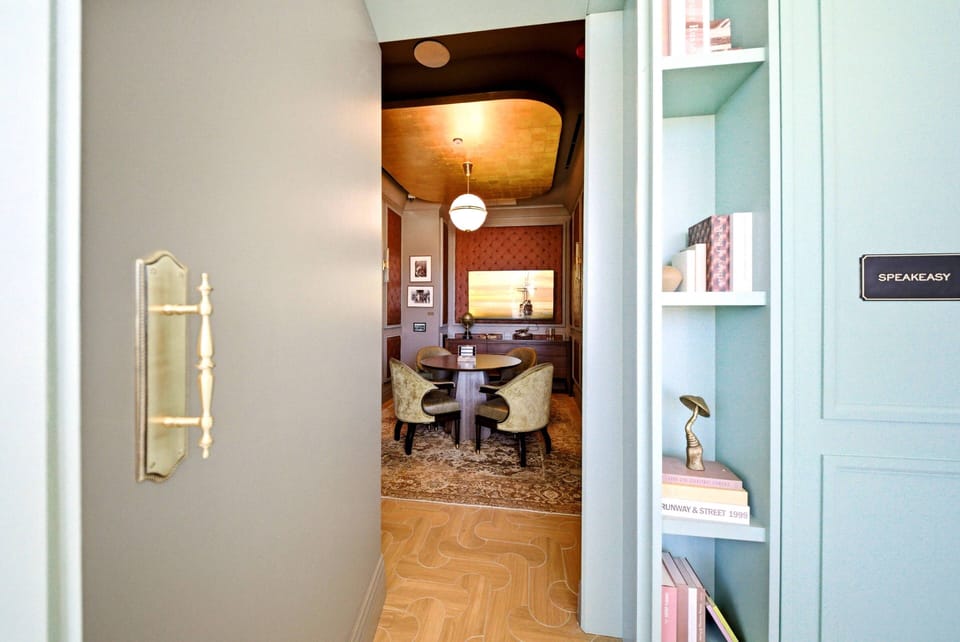 Discover a beautifully designed space where rich textures and thoughtful decor come together. The stylish gray-toned hallway leads to a cozy dining area filled with warm light, ideal for intimate meals and memorable moments.
