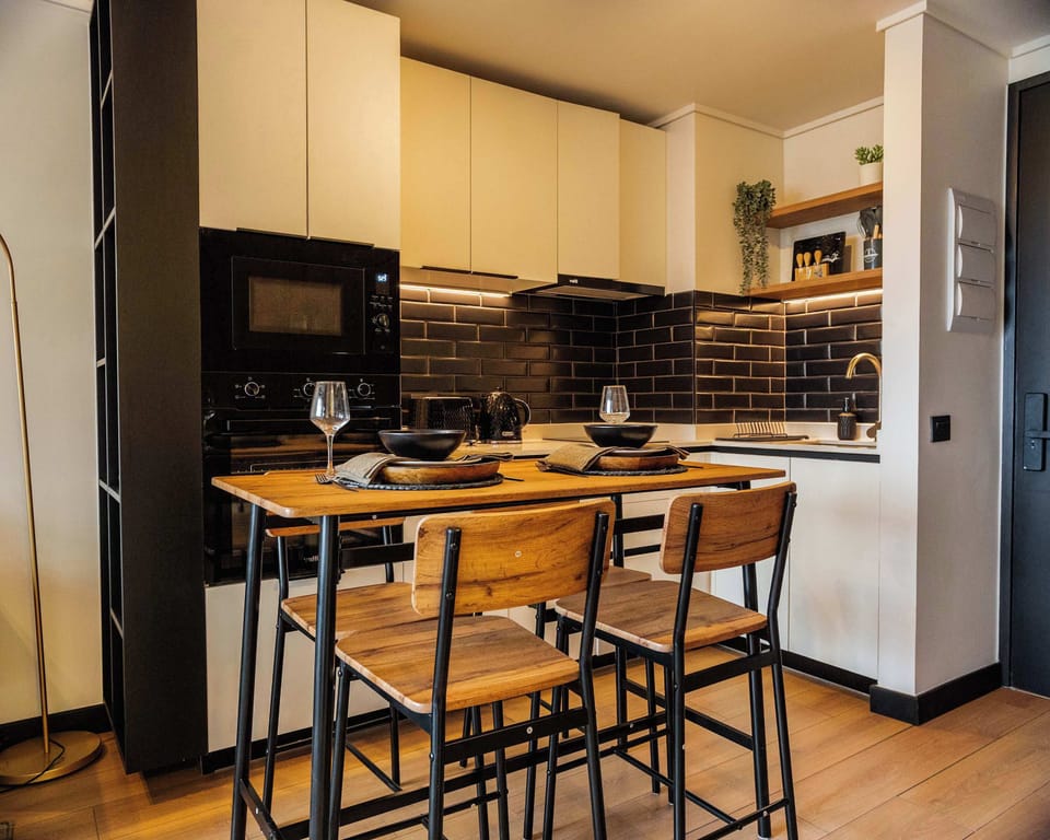 Cozy and modern kitchen with stylish dining area, perfect for intimate meals or casual gatherings.
