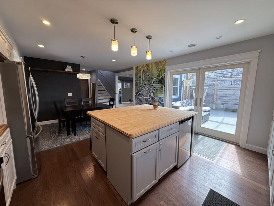 The heart of the house -- a massive kitchen with center island, flowing out to the deck